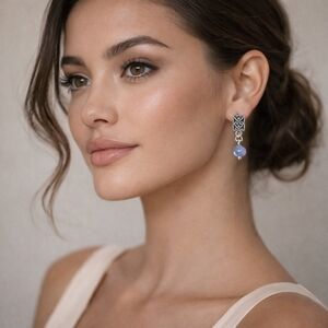 Silver distressed earrings with round blue gem